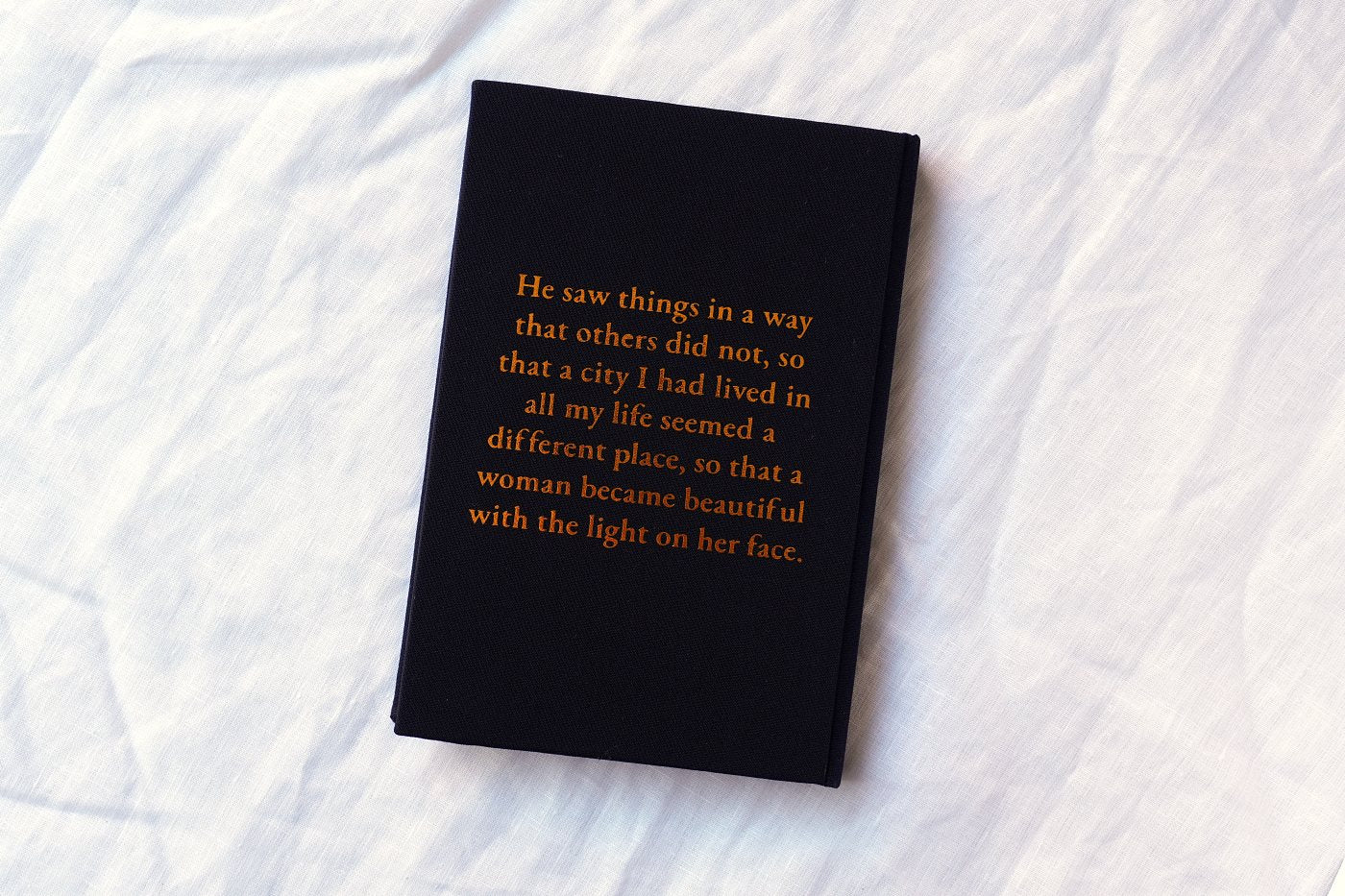 Back board with a line from the novel pressed in gold