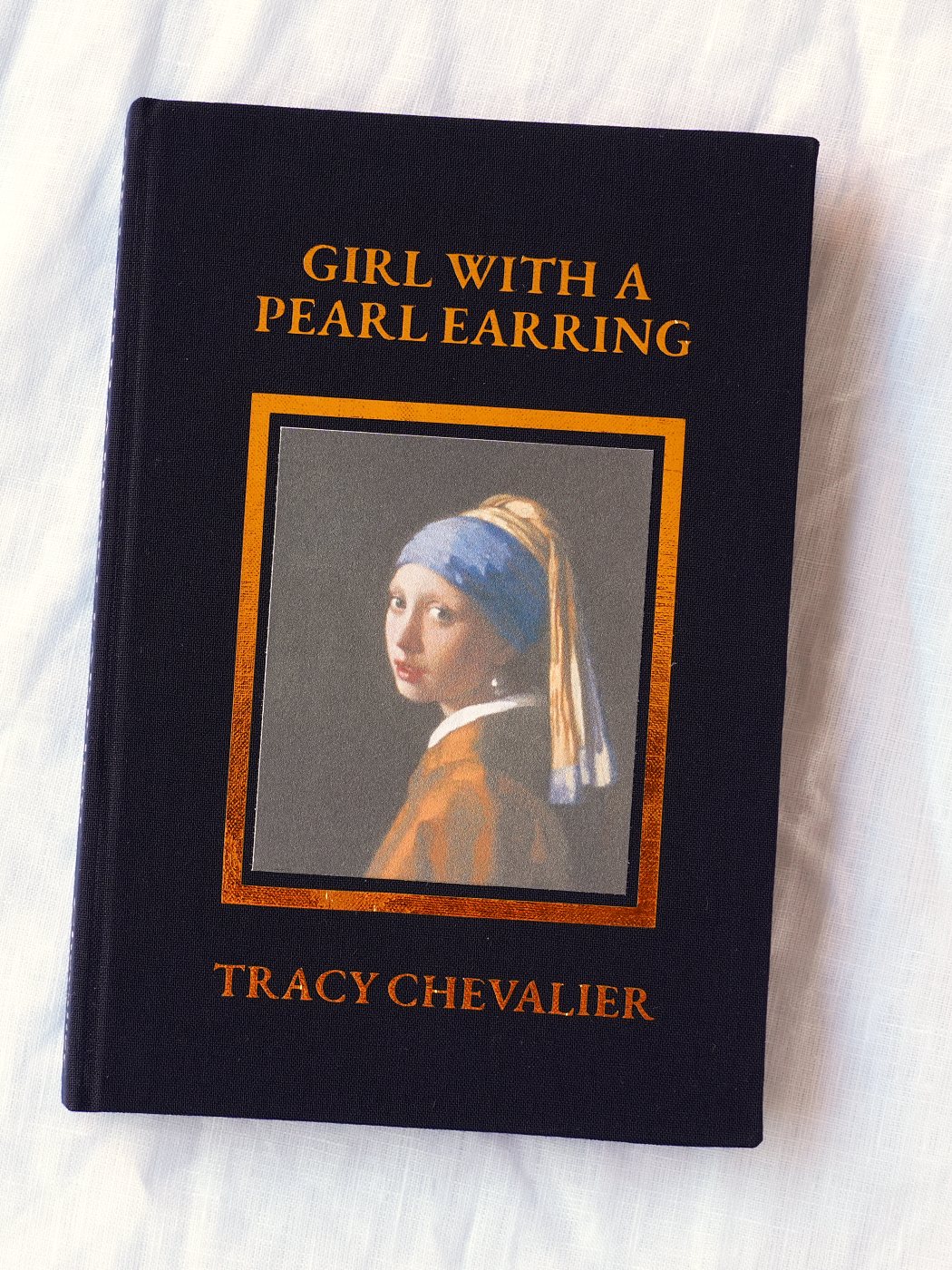 Girl with a Pearl Earring rebound in navy cloth, Vermeer's painting set into the front board