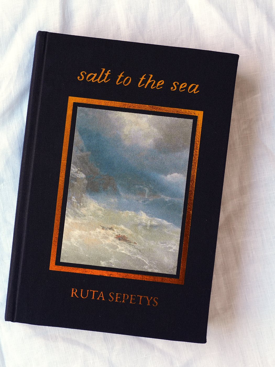 Salt to the Sea rebound in navy cloth, an Aivazovsky seascape set into the front board