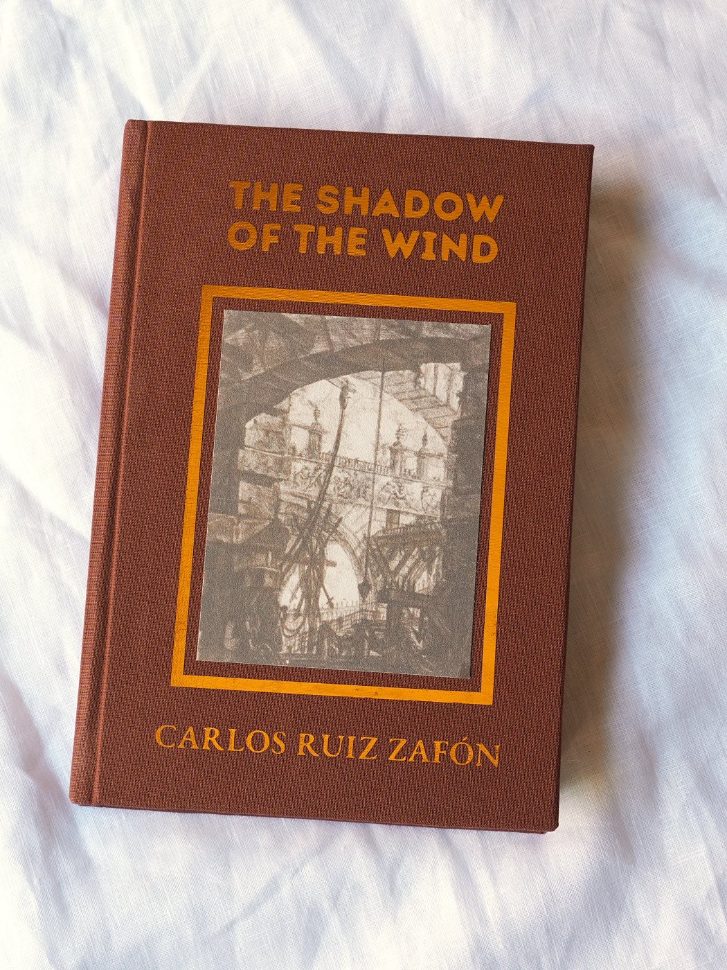 The Shadow of the Wind rebound in oxblood cloth, a Piranesi etching set into the front board